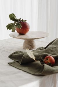 Kaboompics - Wooden Bowl of Mixed Apples on White Linen with Loose Fruit and Soft Window Light