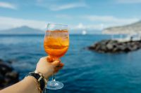 Kaboompics - Aperol Spritz with Island View and Rocky Mediterranean Coast