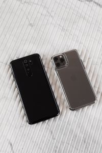 Kaboompics - Vertical Tech Flat Lay of Black and Silver Phone Backs on White Marble