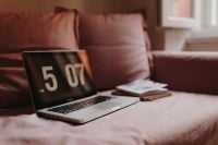 Kaboompics - Laptop and Book on Pink Sofa by a Bright Window