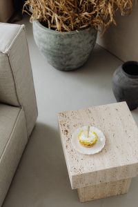 Kaboompics - Small Cake on a Travertine Side Table by a Sofa