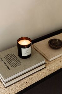 Kaboompics - Black Console with Lit Candle and Glass Object on Lower Shelf