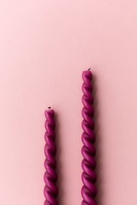 Kaboompics - Two Twisted Pink Candles On Pastel Background