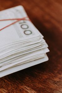 Kaboompics - Close-Up Stack of Polish Zloty Notes with Red String on a Wooden Table