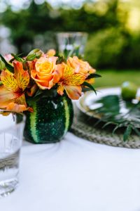 Kaboompics - Orange and Pink Floral Bouquet in Green Vase, Soft-Focus Table Setting
