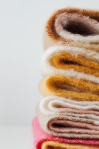Kaboompics - Folded Yellow Fringed Blanket on White