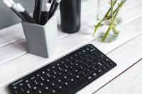 Kaboompics - Black Computer Keyboard beside Concrete Pencil Cup on White Plank Table