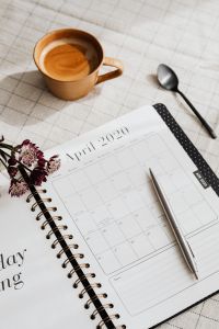 Kaboompics - April 2020 Planner with Coffee, Astrantia and Spoon on Checkered Linen