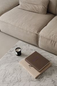 Kaboompics - Neutral Sofa, Design Books and Black Candle on Coffee Table