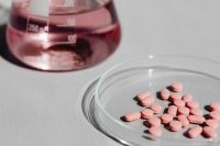 Kaboompics - Pink Flask and Tablets in Overhead Laboratory Composition