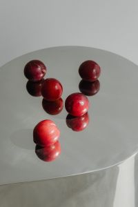 Kaboompics - Red Plums Reflected on Chrome Side Table