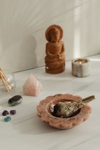Kaboompics - Buddha Statue With Candle Crystals And Matchsticks On Stone Table