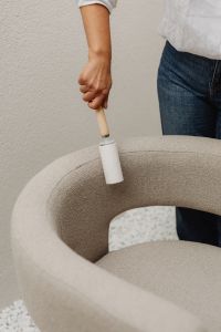 Kaboompics - Woman Removing Lint from a Boucle Chair