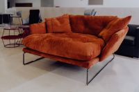 Kaboompics - Rust Orange Velvet Chaise Lounge with Deep Cushions in a Furniture Showroom