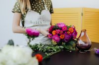 Kaboompics - Florist Working Beside a Colorful Bouquet and Vase