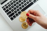 Kaboompics - Hand Holding Bitcoin Coin Near Laptop