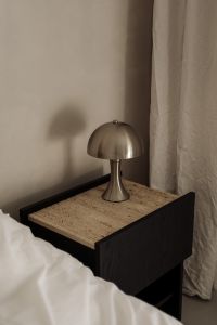 Kaboompics - Dome Table Lamp on Textured Nightstand with Soft Bedroom Light