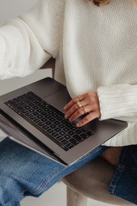 Kaboompics - Faceless Woman in White Sweater Working on Laptop