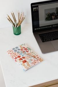Kaboompics - Green Pencil Cup, Laptop and White Flower Vase on Office Desk