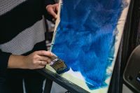 Kaboompics - Wide Brush Applying Cobalt Blue Paint to Canvas, Close-Up Artistic Process