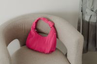 Kaboompics - Bright Pink Textured Handbag on a Neutral Chair