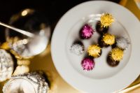 Kaboompics - Chocolate Pralines and Crystal Candleholders in a Golden New Year's Eve Table Setting