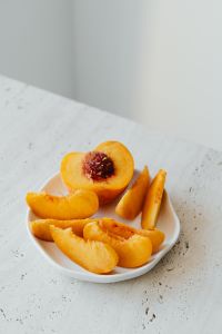 Kaboompics - Vertical Peach Still Life with Fruit Slices and Soft Copy Space