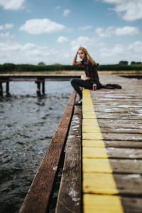 Kaboompics - Beautiful blonde woman on a wooden pier by the lake