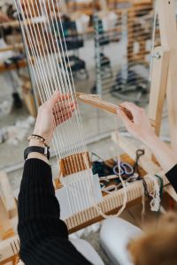Kaboompics - Woman Adjusting Warp Threads on a Weaving Loom