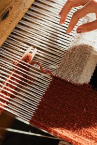 Kaboompics - Hand Crafting a Woven Rug on a Loom