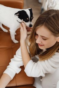Kaboompics - Woman with Small Dog on Cozy Sofa