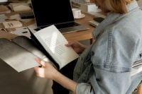 Kaboompics - Interior Designer Reviewing Design Documents and Material Swatches beside Laptop