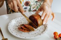 Kaboompics - Woman Cutting Fresh Produce at a White Table