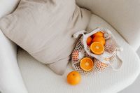 Kaboompics - Neutral Living Room Still Life with Oranges in a Reusable Mesh Shopping Bag