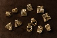 Kaboompics - Gold Statement Earrings Collection on Brown Background