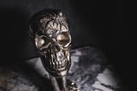Kaboompics - Upright Silver Skull Figurine on Marble, Dark Halloween Still Life