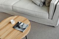 Kaboompics - Wooden Coffee Table with Book and Candle Beside Linen Sofa