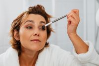 Kaboompics - Close-Up of a Middle-Aged Woman Applying Eye Shadow with a Makeup Brush