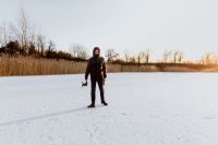 Kaboompics - Man and his dog in middle of frozen lake