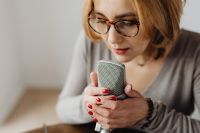 Kaboompics - Woman Holding a Studio Microphone with Both Hands for Whispered ASMR