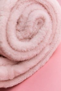 Kaboompics - Rolled Soft Pink Blanket Texture On Pink Background