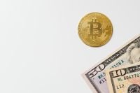 Kaboompics - Bitcoin Coin Above US Dollar Bills