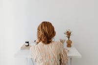 Kaboompics - Back View of Woman Working at Laptop in Neutral Home Office