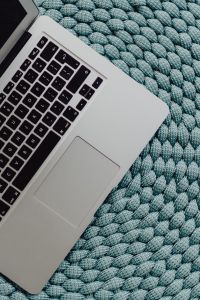 MacBook Laptop on a blue pouf