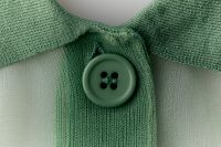 Kaboompics - Green knit cardigan collar with button detail macro shot