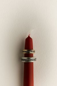 Kaboompics - Red Candle Balanced on Rings with Copy Space