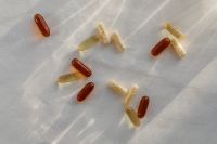 Kaboompics - Scattered Vitamins and Capsules on Sheer Fabric