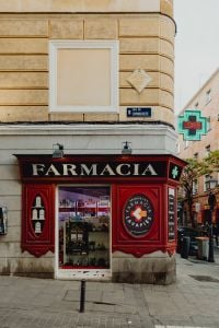 Kaboompics - Old-Fashioned Pharmacy Window with Green Cross Sign in Madrid