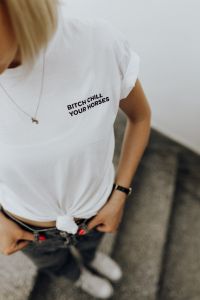Kaboompics - White Graphic T-Shirt and Gold Necklace, Casual Streetwear Detail for Fashion Content