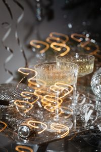 Kaboompics - Champagne Coupes with Golden Curly Streamers